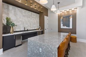Surprise apartment for rent - a kitchen with a large marble counter top and a long table