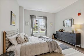 Worcester apartment for rent - a bedroom with a bed and a dresser and a window
