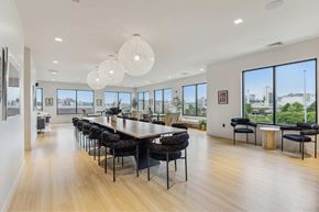 Worcester apartment for rent - a dining room with a long table and chairs and large windows
