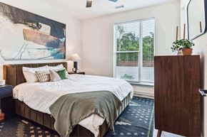 Nashville apartment for rent - a bedroom with a bed and a painting on the wall