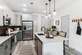Nashville apartment for rent - an open kitchen with a large island and stainless steel refrigerator