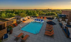 Annapolis apartment for rent - a swimming pool on the rooftop of a hotel with a city in the background