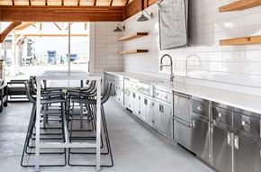 Heber apartment for rent - A large outdoor kitchen area with seating areas and a large TV for gathering together