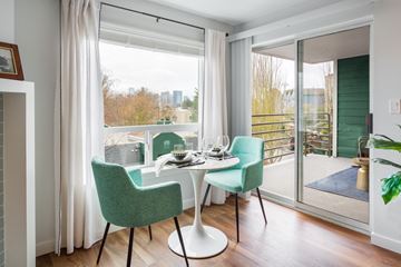 Seattle apartment for rent - a living room with a table and chairs and a balcony