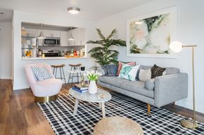 Seattle apartment for rent - a living room with a couch and a table and a kitchen at The Eden, Seattle Washington