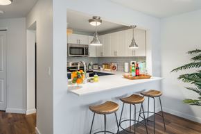 Seattle apartment for rent - a kitchen with a white counter top and three stools at The Eden, Seattle, WA