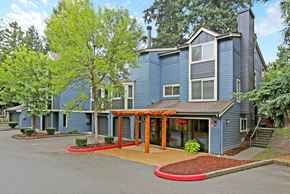 Kirkland apartment for rent - Two story building exterior with pergola entrance at Hubbard's Crossing Apartments, Kirkland, WA
