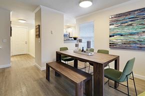 Kirkland apartment for rent - Dining area with wood table and green chairs at Hidden River Townhomes Apartments, Kirkland, WA