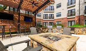 Atlanta apartment for rent - a patio with a fire pit in front of an apartment building