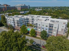 Charlotte apartment for rent - a view of a building from above with a pool and trees