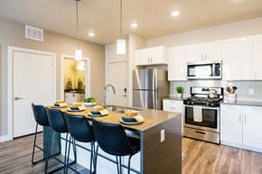 Salt Lake City apartment for rent - an open kitchen with a large island with blue chairs