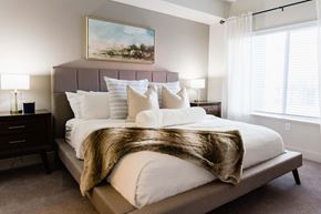 Salt Lake City apartment for rent - a bedroom with a large bed and a window