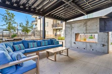 Salt Lake City apartment for rent - a living room with blue couches and a fireplace