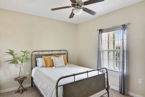 Killeen apartment for rent - a bedroom with a bed and a ceiling fan