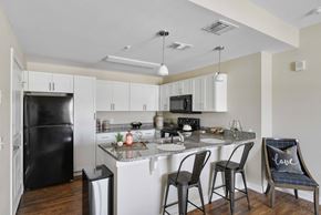 Killeen apartment for rent - a kitchen with a counter top with bar stools