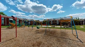 Louisville apartment for rent - a playground with a swing set and other playground equipment