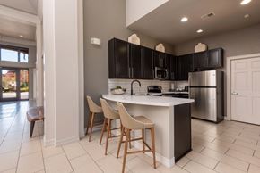 Lakewood apartment for rent - a kitchen with black cabinets and a white counter top
