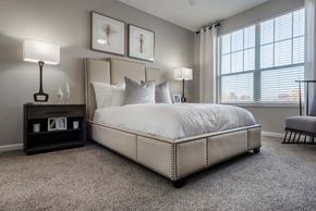 Lakewood apartment for rent - a bedroom with a bed and a ceiling fan
