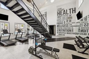 Ladson apartment for rent - a gym with stairs and weights and a wall with words on it