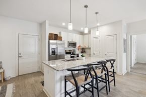 Ladson apartment for rent - a kitchen with a marble counter top and bar stools