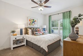 Ladson apartment for rent - a bedroom with a bed and a ceiling fan