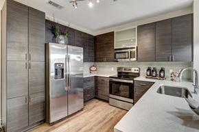 Charlotte apartment for rent - a kitchen with stainless steel appliances and wooden cabinets