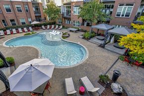 Charlotte apartment for rent - an aerial view of a swimming pool and patio with umbrellas