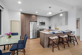 New Rochelle apartment for rent - A modern kitchen with a dining table and chairs.