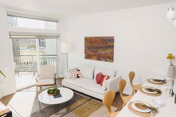 Redmond apartment for rent - A modern living room with a white couch and a painting on the wall.