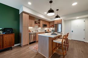 Arlington apartment for rent - A modern kitchen with wooden cabinets and a central island.