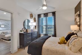 Lakewood apartment for rent - A bedroom with a large bed and a ceiling fan.