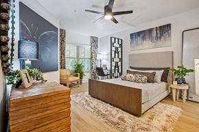 Savannah apartment for rent - A bedroom with a large bed and a wooden dresser.