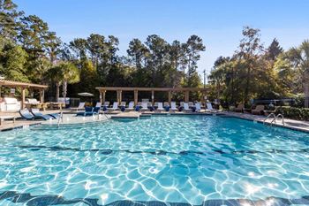 Resort-inspired saltwater swimming pool with poolside cabanas
