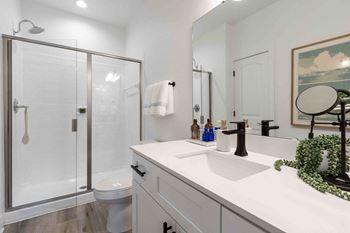 Glass-enclosed shower with modern subway tile