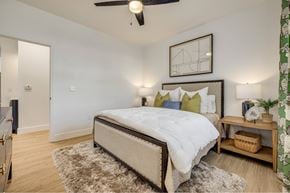 Charlotte apartment for rent - A bedroom with a large bed and a ceiling fan.