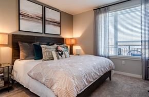 King Of Prussia apartment for rent - A bedroom with a large bed and a window overlooking the ocean.