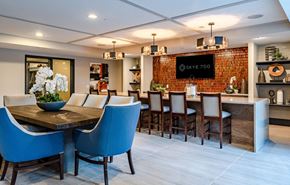King Of Prussia apartment for rent - A modern dining room with a wooden table and blue chairs.