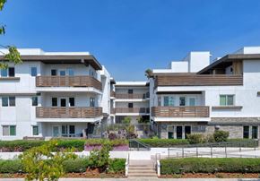 Los Angeles apartment for rent - A modern apartment complex with white buildings and balconies.