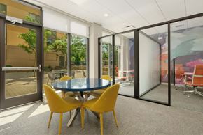 Beverly apartment for rent - A conference room with a glass wall and yellow chairs.