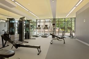 Beverly apartment for rent - A gym with a variety of equipment including treadmills, weights, and exercise machines.