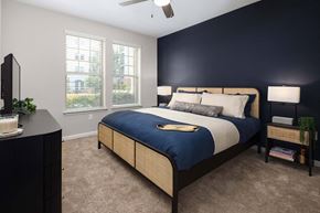 Brookhaven apartment for rent - A bedroom with a bed, nightstand, and a ceiling fan.