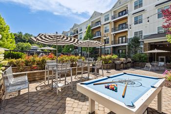 Outdoor courtyard with games including ping pong, billiards and foosball