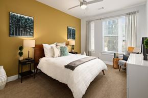 Atlanta apartment for rent - A bedroom with a large bed and a ceiling fan.