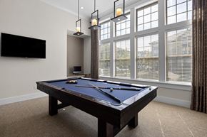 Raleigh apartment for rent - A pool table in a room with a television and a window.