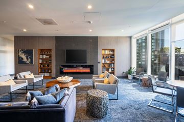 San Francisco apartment for rent - A modern living room with a dark blue sofa and a fireplace.