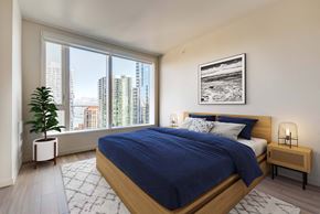 San Francisco apartment for rent - A bedroom with a large bed and a view of the city.