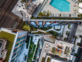 Washington apartment for rent - A bird's eye view of a modern building with a pool and a bridge.