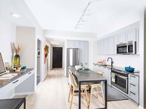 Washington apartment for rent - A modern kitchen with a dining table and chairs.