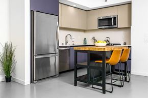 Glendale apartment for rent - A kitchen with a table and chairs and a refrigerator.