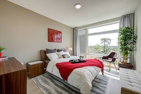 Glendale apartment for rent - A bedroom with a large bed and a red blanket.